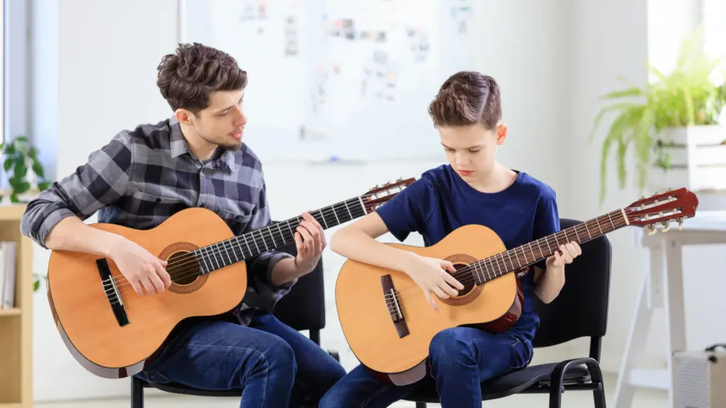 A kid learning the guitar
