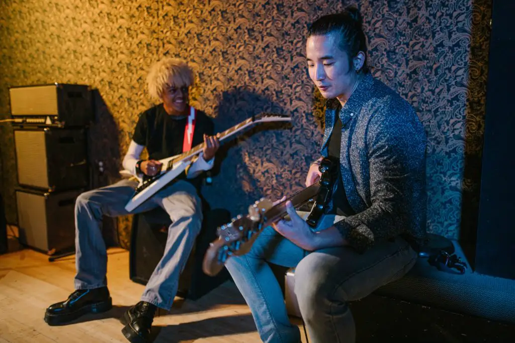 Men playing guitar together and jamming